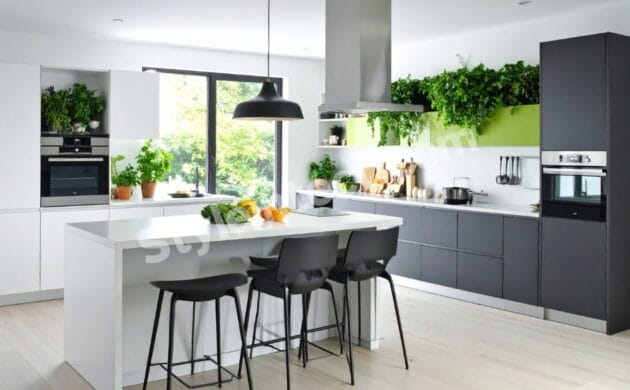 Modern Modular Kitchen Design with white and grey cabinets, spacious island, built-in ovens, pendant lighting, indoor greenery, and contemporary open kitchen interior.