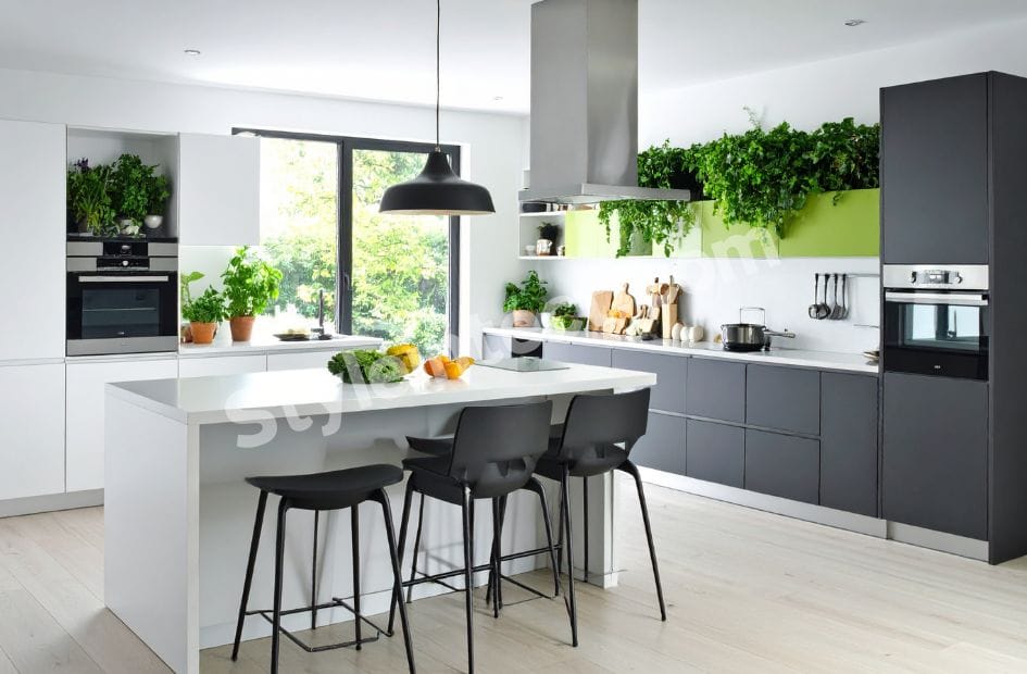 Modern Modular Kitchen Design with white and grey cabinets, spacious island, built-in ovens, pendant lighting, indoor greenery, and contemporary open kitchen interior.
